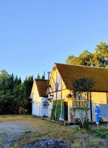 a yellow and white house with a blue fire hydrant at Kirisame Magic Shop霧雨魔法店民泊伊勢市 in Ise