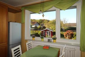 a kitchen with a table and a window with a red house at Ferienwohnung Kirsch in Sankt Wendel