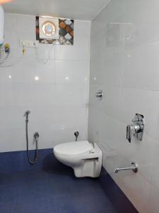 a bathroom with a toilet and a shower in it at Glory Farm in Vadāli +14 photos