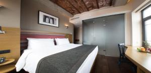 a bedroom with a large bed and a table and a desk at Bankerhan Hotel Galata - Adults Only Special Category in Istanbul