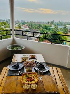 a table with food on top of a balcony at Villa SeaLoom in Galle