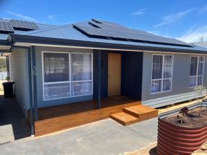 a house with a deck with a solar roof at Pelicans Perch in Mannum +6 photos
