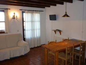 a living room with a table and a couch at Apartamento Fuente De Somave in Cahecho +22 photos