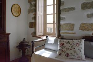 a living room with a pillow and a window at En Patmo Holiday Home in Patmos