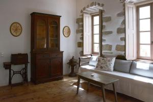 a living room with a couch and a table at En Patmo Holiday Home in Patmos