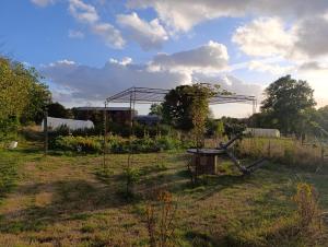 a garden with a metal structure in a field at La Ferme du Papillon in Pougne-Hérisson
