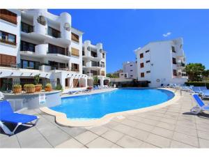 a large swimming pool in front of a building at Carabela in Port d'Alcudia