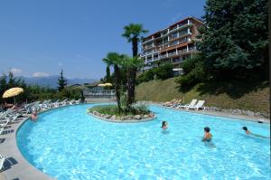 a group of people in a swimming pool at a hotel at Hotel Colibrì in Lugano