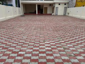 a red and white brick floor in front of a building at Hari Vatika in Varanasi