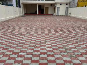 a red and white tiled floor in front of a building at Hari Vatika in Varanasi