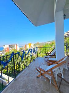 a balcony with two chairs and a view of the ocean at Hillside Villa with ocean views in Puerto Vallarta