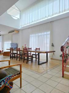 a living room with a table and chairs at Hillside Villa with ocean views in Puerto Vallarta