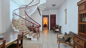a living room with a spiral staircase in a house at Hillside Villa with ocean views in Puerto Vallarta
