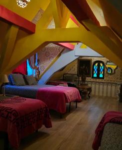 a room with two beds and a ceiling with beams at Hotel Mozart in Brussels