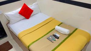a bedroom with a bed with a red pillow at Hotel Angels Inn By Glitz Hotels in Mumbai