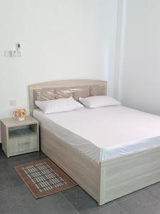 a bed with white sheets and pillows in a room at Sunray Homes in Disagewatta