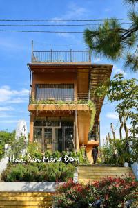 een gebouw met een balkon aan de zijkant bij Han San Homestay Măng Đen in Kon Plong +53 foto's