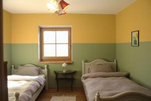 two beds in a room with green and yellow walls at haus nummer fünf - inklusive Chiemgau Karte in Siegsdorf