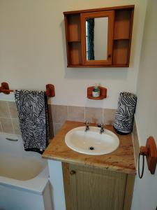 a bathroom with a sink and a mirror and a tub at Heights in Cedara +28 photos