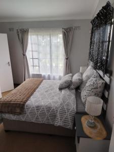 a bedroom with a large bed with a window at Heights in Cedara