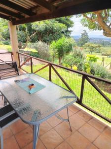 a table on a balcony with a view at Heights in Cedara