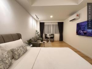 a bedroom with a bed and a living room at Second Home - Kota Kemuning in Shah Alam