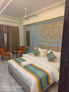 a bedroom with two beds with pillows on them at KDM Hotel Indore Palace- a walk away from Saibaba Temple in Shirdi