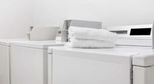 a pile of towels sitting on top of washing machines at Ramada Limited Norfolk in Greenwich