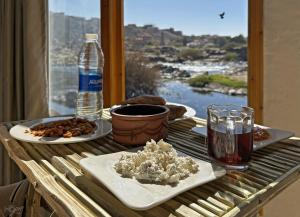 a table with two plates of food and a glass of water at ASSINGAR Island in Aswan +117 photos