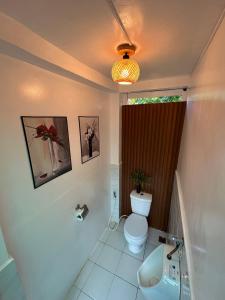 a bathroom with a toilet and a sink at 6227 Guesthouse in San Juan