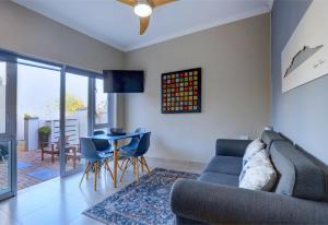 a living room with a couch and a table at Albatross @ Kingswood in George