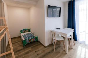 a small room with a table and a table and a chair at INLE Homestay in Nová Lesná