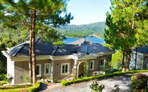 a house with a view of a lake at Dalat Edensee Lake Resort & Spa in Da Lat