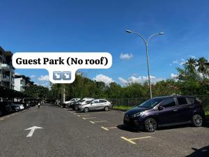 a bunch of cars parked in a parking lot at SDC Suite Home 6 in Lahad Datu