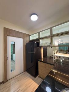 a kitchen with a black counter and a table at SDC Suite Home 6 in Lahad Datu