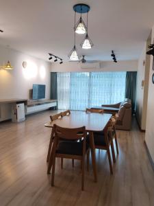 a living room with a table and chairs and a couch at SDC Suite Home 6 in Lahad Datu