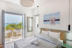 a bedroom with a bed and a view of the ocean at Aegean Paradiso Vacation Club - "Adults Only" in Azolimnos Syros +281 photos