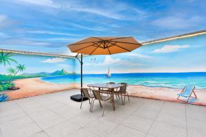 a table with an umbrella on a beach at WEN SI TE HOTEL in Shangta