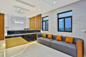 a waiting room with a couch and orange pillows at WEN SI TE HOTEL in Shangta