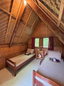 a bedroom with two beds in a attic at 6227 Guesthouse in San Juan