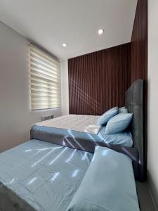 a bedroom with two beds and a window at Vibe and Stay - Staycation home near Tagaytay in Calo +30 photos