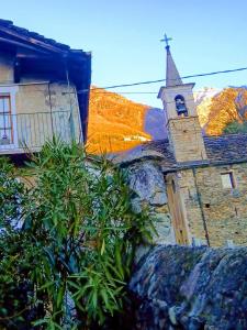 an old church with a steeple and a tower at La Casa Antica in Pont-Saint-Martin
