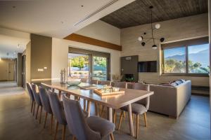 a dining room with a large wooden table and chairs at Villa Aori in Kariá