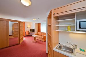 a hotel room with a bathroom and a living room at Hotel Bären in Rottweil