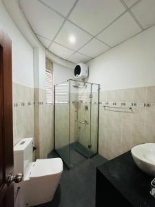 a bathroom with a shower and a toilet and a sink at Kandy krush Hotel in Kandy