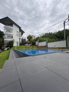 a swimming pool in front of a house at Kandy krush Hotel in Kandy
