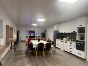 a kitchen and dining room with a table and chairs at Bob Residence- Chic Penthouse in Cluj-Napoca