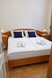 a bedroom with a large bed with two towels on it at Ana Marija Apartment - Vila Golf in Rogaška Slatina