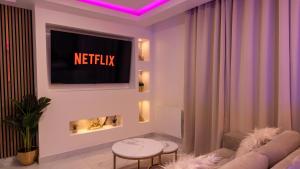 a living room with a couch and a tv at MagicSpa Gold in Chilly-Mazarin +10 photos