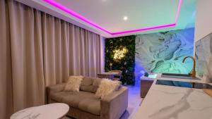 a living room with a couch and a purple lighting at MagicSpa Gold in Chilly-Mazarin